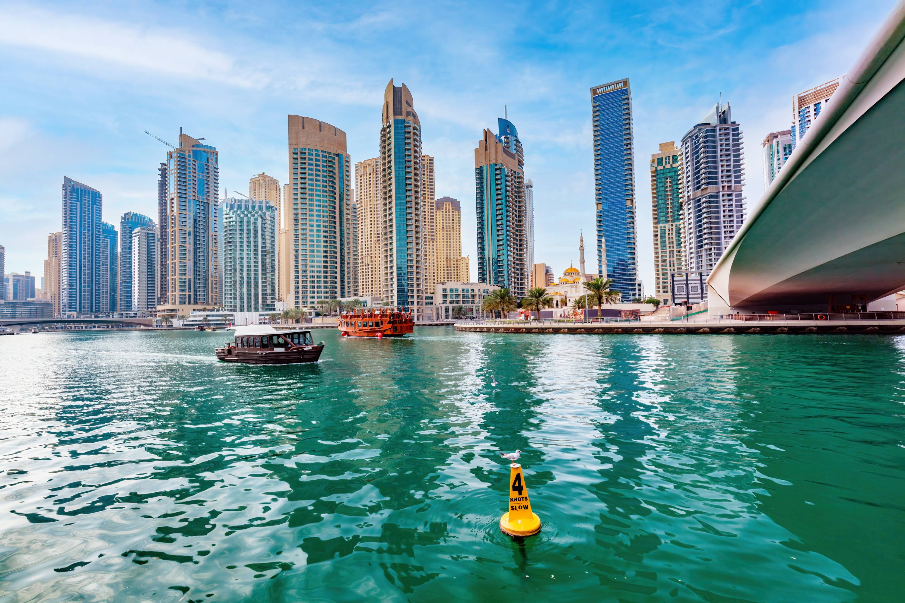 Bridge over Dubai marina in UAE. High-rise residential buildings, business skyscrapers